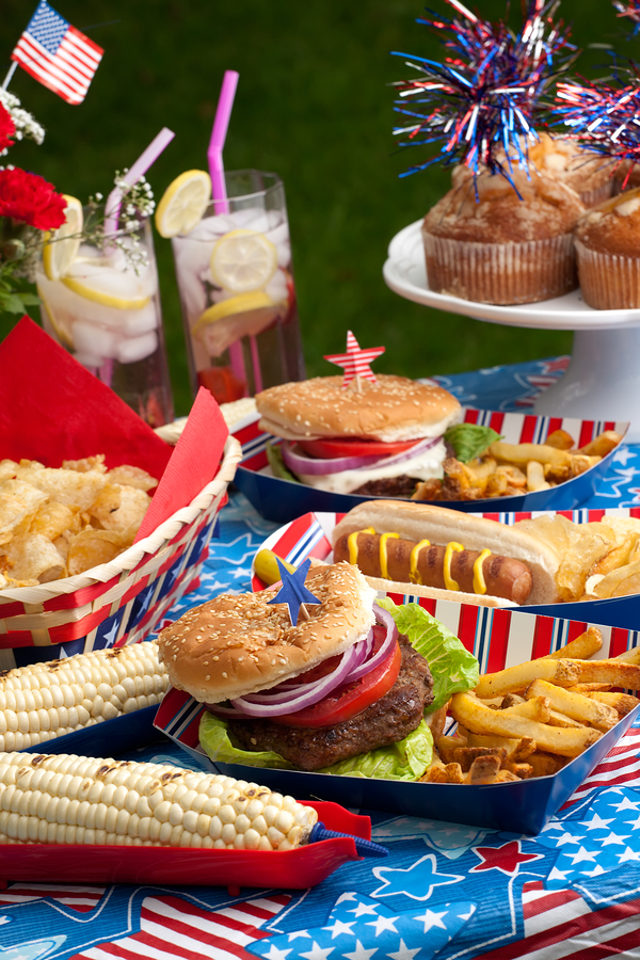 Hot dogs corn and burgers on 4th of July picnic in patriotic theme